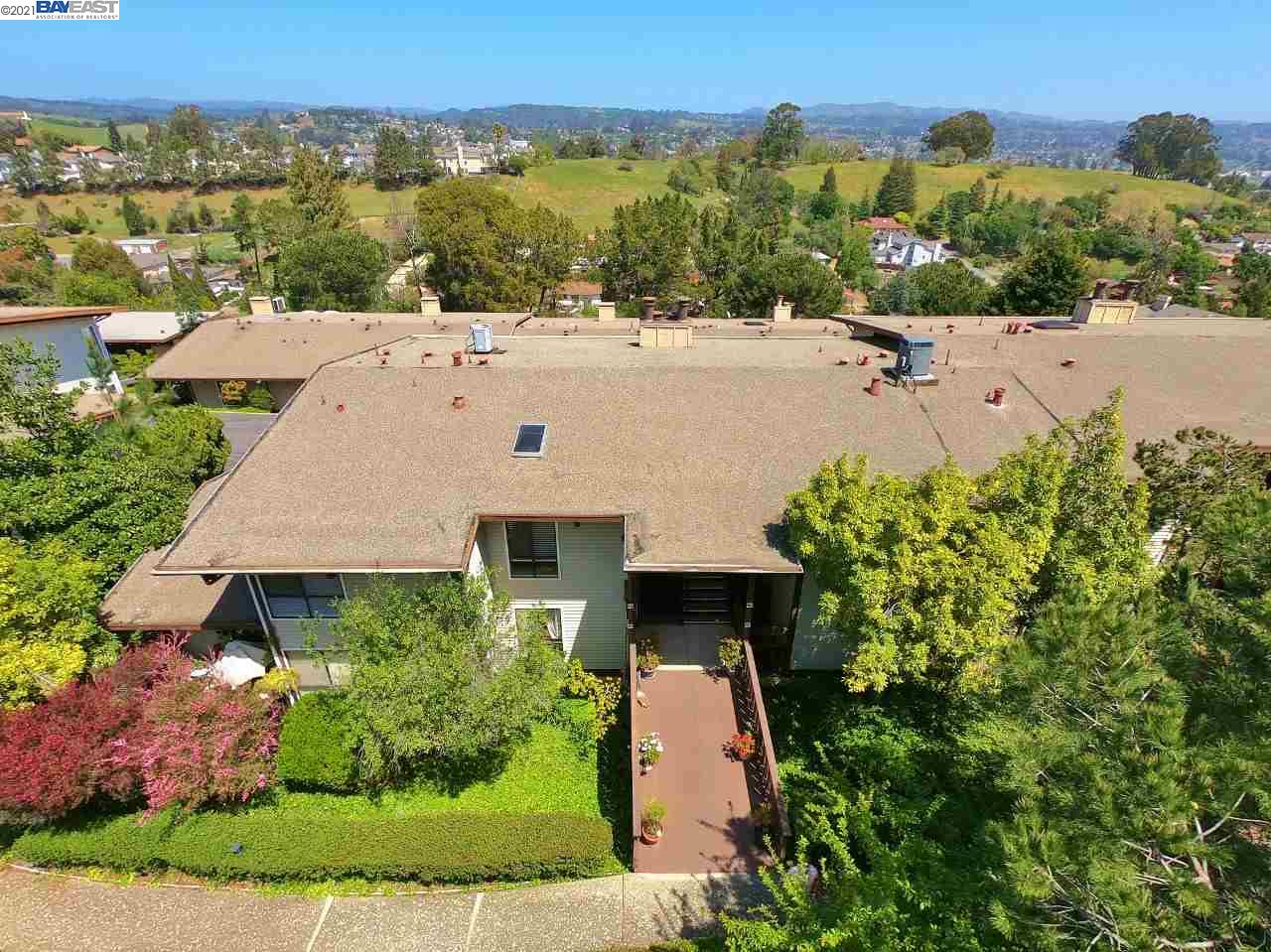 an aerial view of a house with a yard and lake view