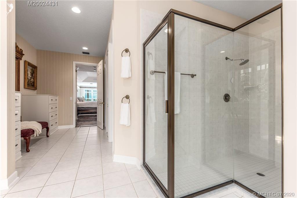 2021 Southeast Riverside Drive Stuart, FL 34996 - Photo 18 of 47 a bathroom with a shower and a mirror