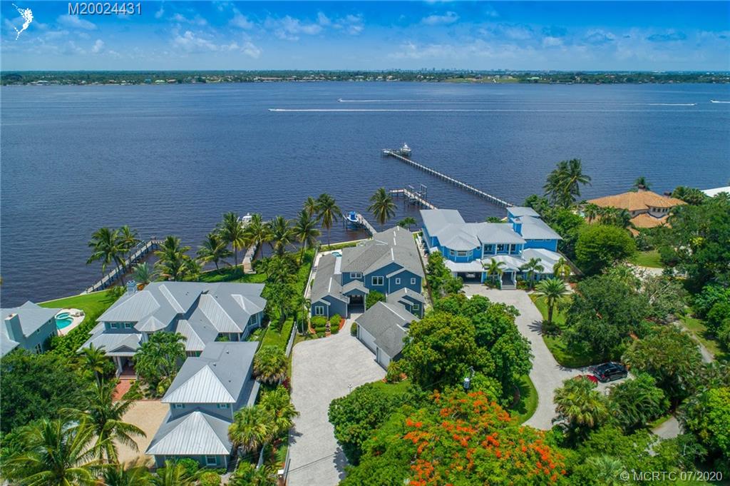2021 Southeast Riverside Drive Stuart, FL 34996 - Photo 3 of 47 an aerial view of house with yard and lake view