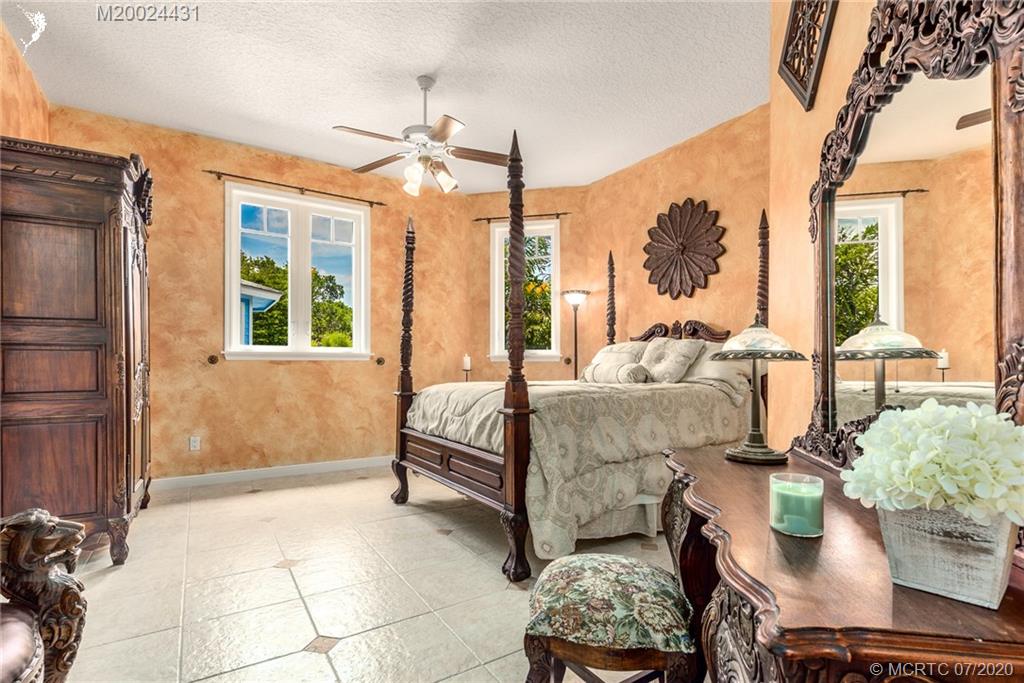 2021 Southeast Riverside Drive Stuart, FL 34996 - Photo 38 of 47 a bedroom with furniture and a large window