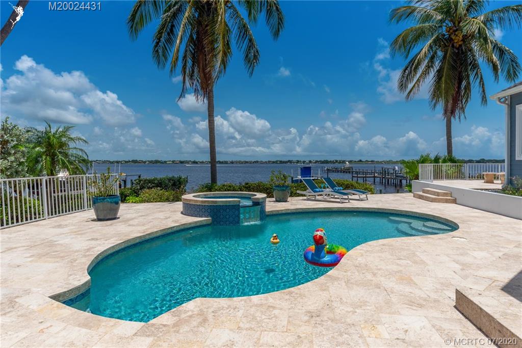 2021 Southeast Riverside Drive Stuart, FL 34996 - Photo 46 of 47 a view of a swimming pool with a patio and plants
