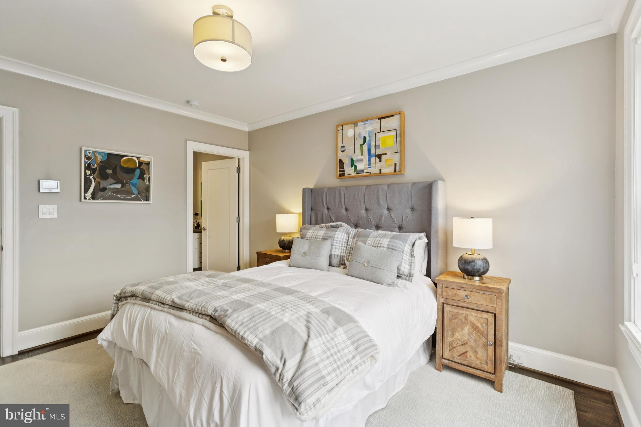 1724 34th Street Northwest Washington, DC 20007 - Photo 14 of 38 a bedroom with a bed and a chandelier