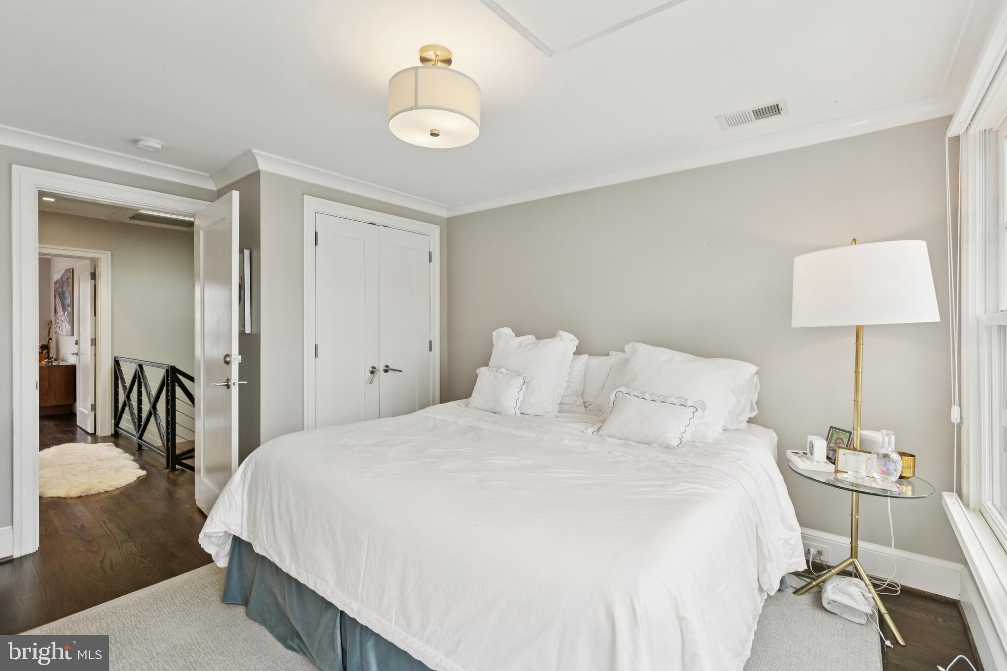 1724 34th Street Northwest Washington, DC 20007 - Photo 18 of 38 a bedroom with a bed and a chandelier