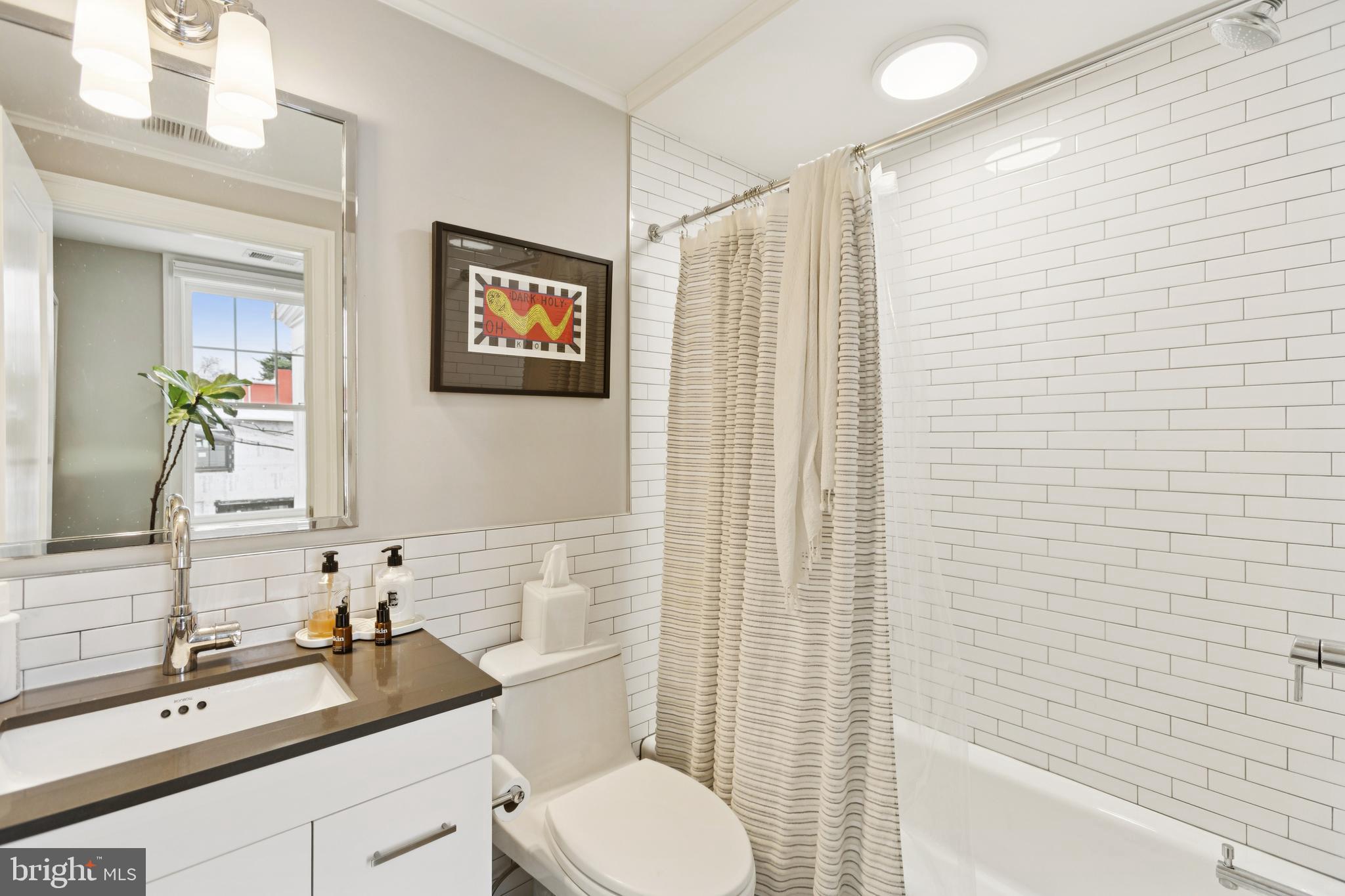 1724 34th Street Northwest Washington, DC 20007 - Photo 20 of 38 a bathroom with a sink a toilet and shower