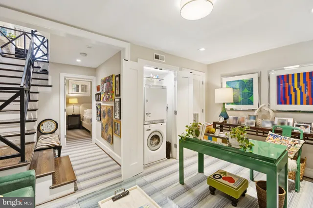 a living room with furniture and a book shelf