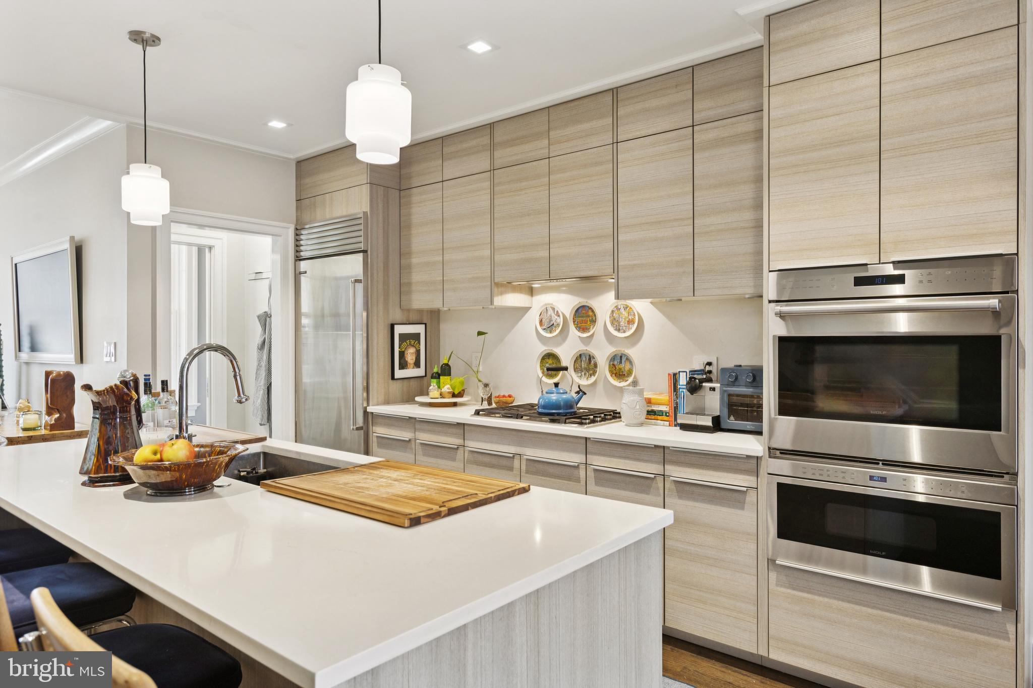 1724 34th Street Northwest Washington, DC 20007 - Photo 4 of 38 a kitchen with kitchen island granite countertop a stove a sink and a counter space