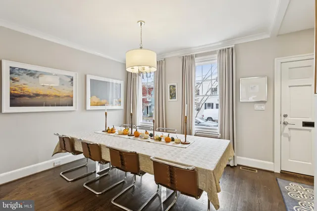 a view of a dining room with furniture wooden floor and chandelier
