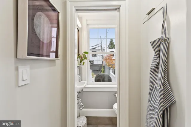 a bathroom with a toilet a sink and a window