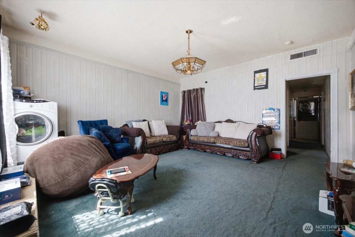 802 South 11th Avenue Pasco, WA 99301 - Photo 3 of 24 a living room with furniture a couch and a chandelier