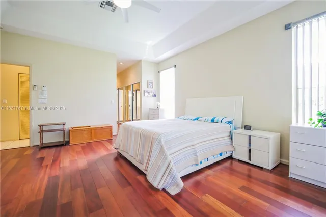 a spacious bedroom with a bed and a table in it