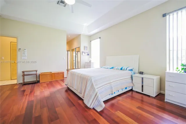 a spacious bedroom with a bed and a table in it