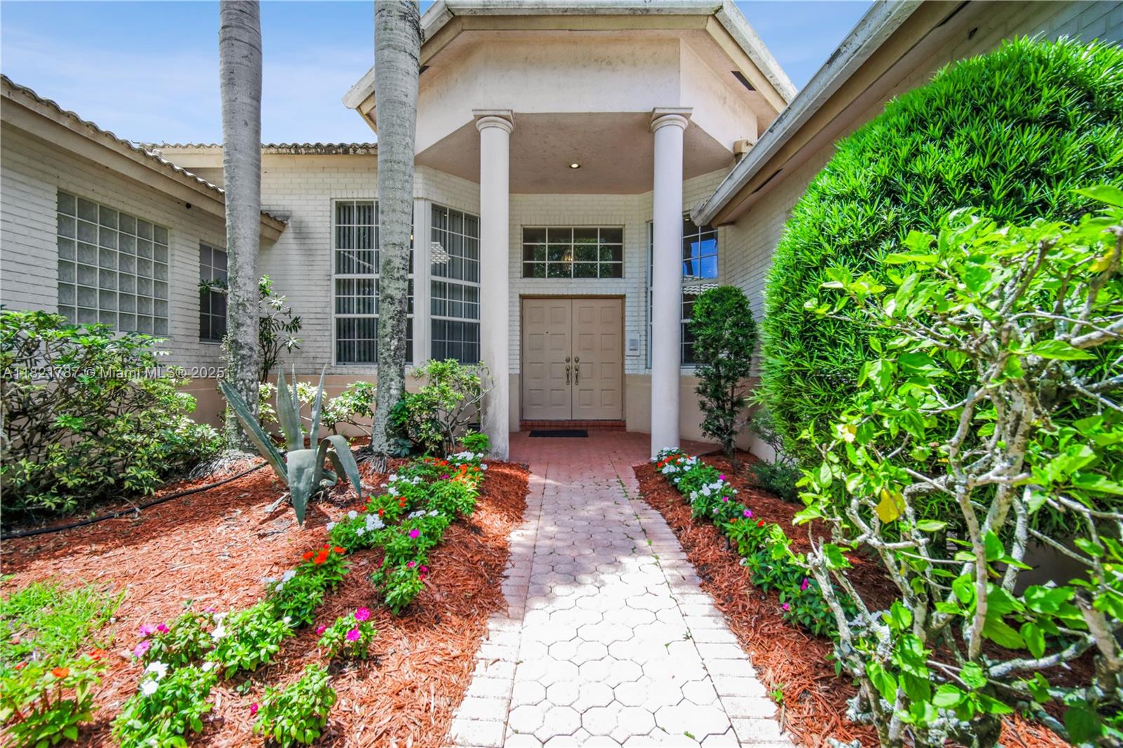 12620 Countryside Terrace Cooper City, FL 33330 - Photo 2 of 40 a view of a pathway with flower pots