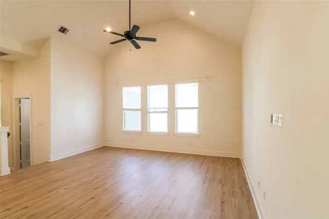 a view of a room with a wooden floor and a window