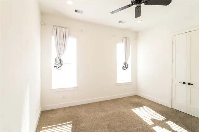 a view of an empty room and a window