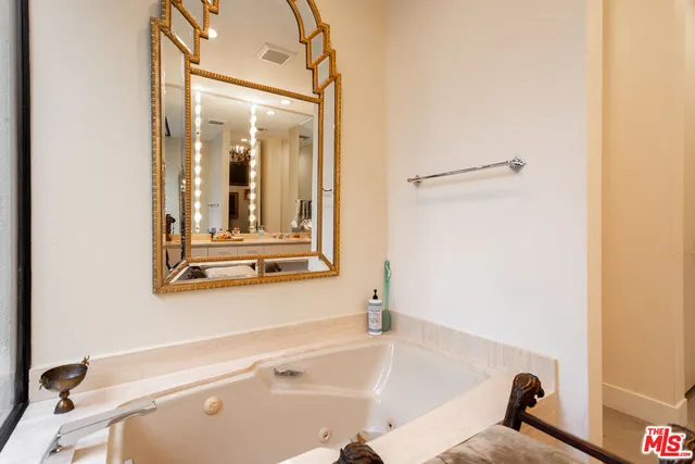 a bedroom with a bed and a mirror