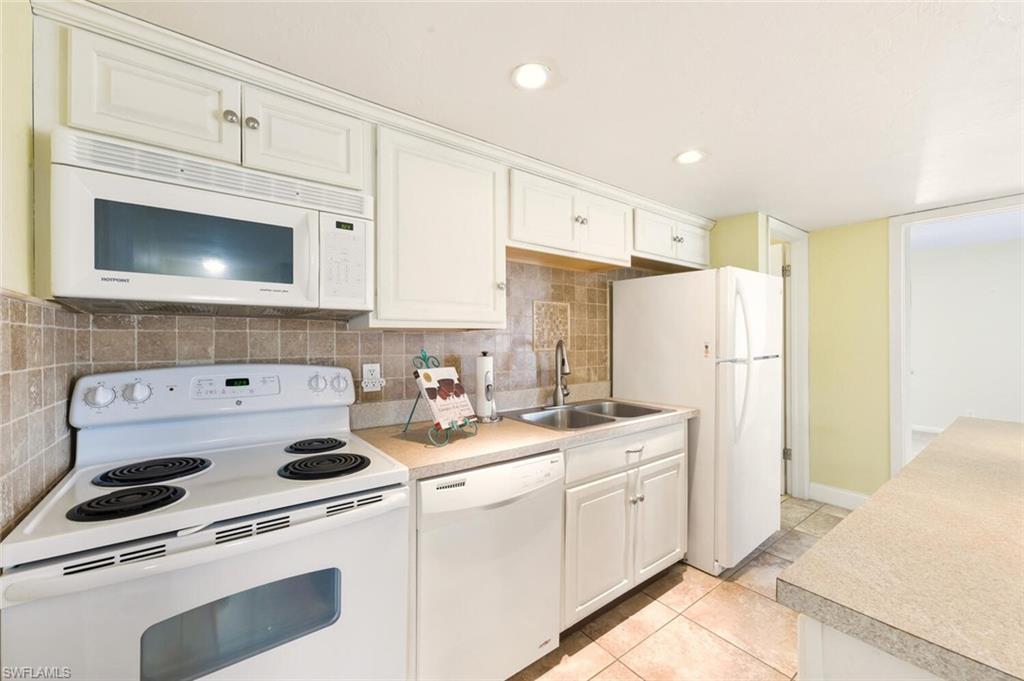 272 Palm Drive, Unit 2 Naples, FL 34112 - Photo 17 of 44 a kitchen with appliances a sink a counter top space and cabinets