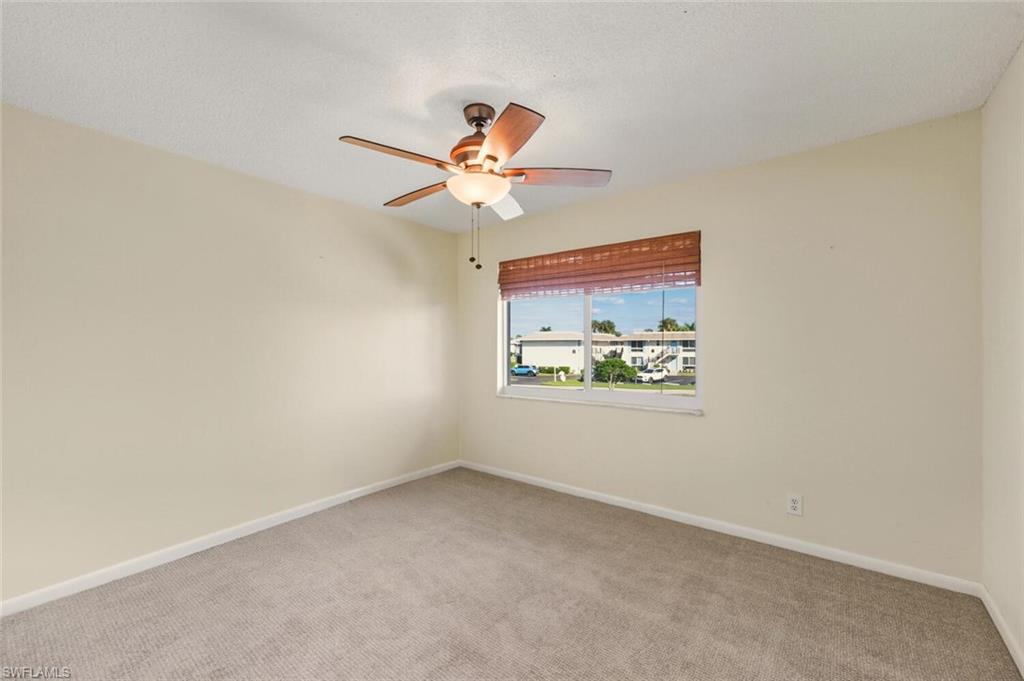 272 Palm Drive, Unit 2 Naples, FL 34112 - Photo 26 of 44 an empty room with windows and fan