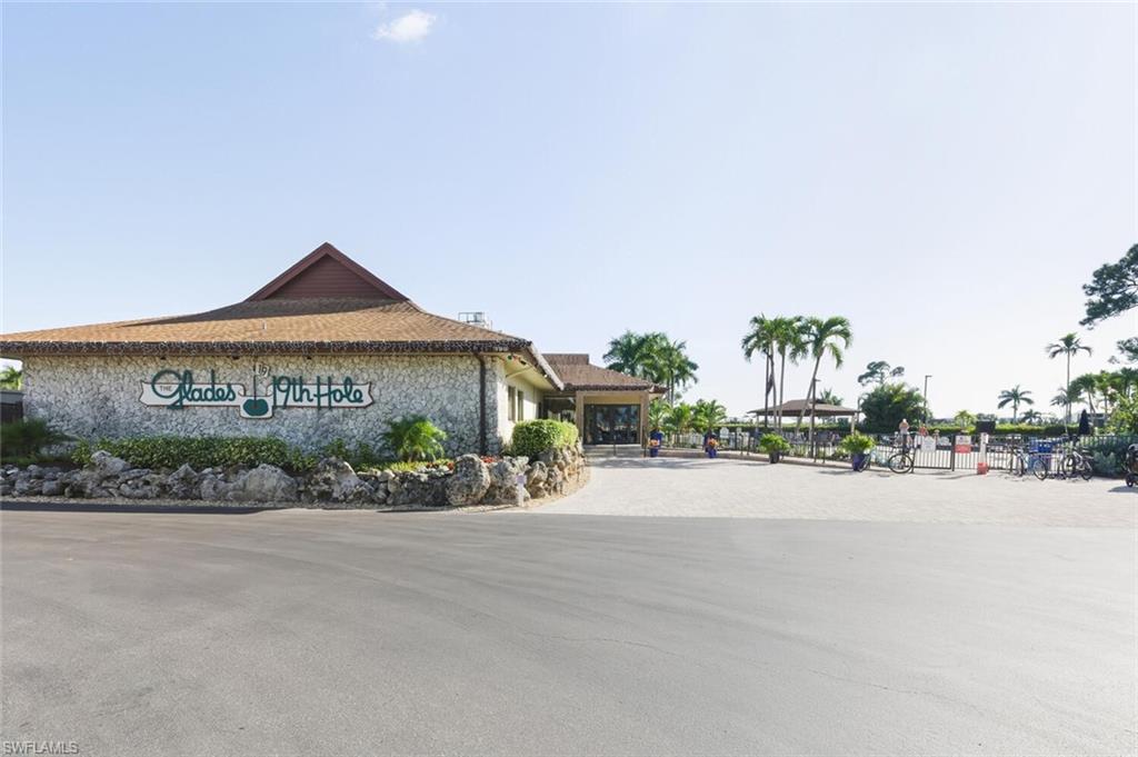 272 Palm Drive, Unit 2 Naples, FL 34112 - Photo 41 of 44 a front view of a house with a garden and pathway