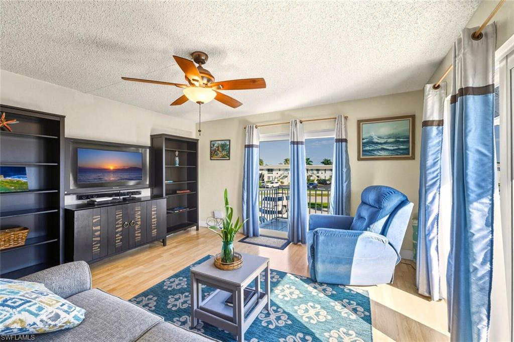 272 Palm Drive, Unit 2 Naples, FL 34112 - Photo 6 of 44 a living room with furniture and a flat screen tv