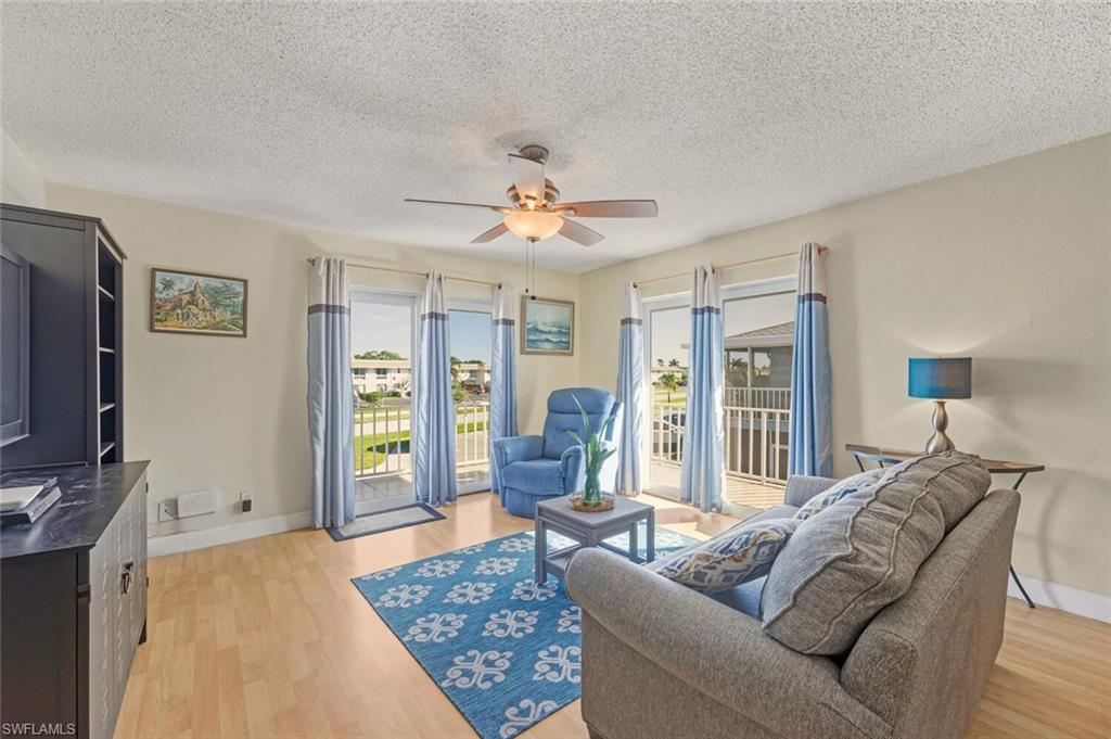 272 Palm Drive, Unit 2 Naples, FL 34112 - Photo 7 of 44 a living room with furniture a ceiling fan and a window