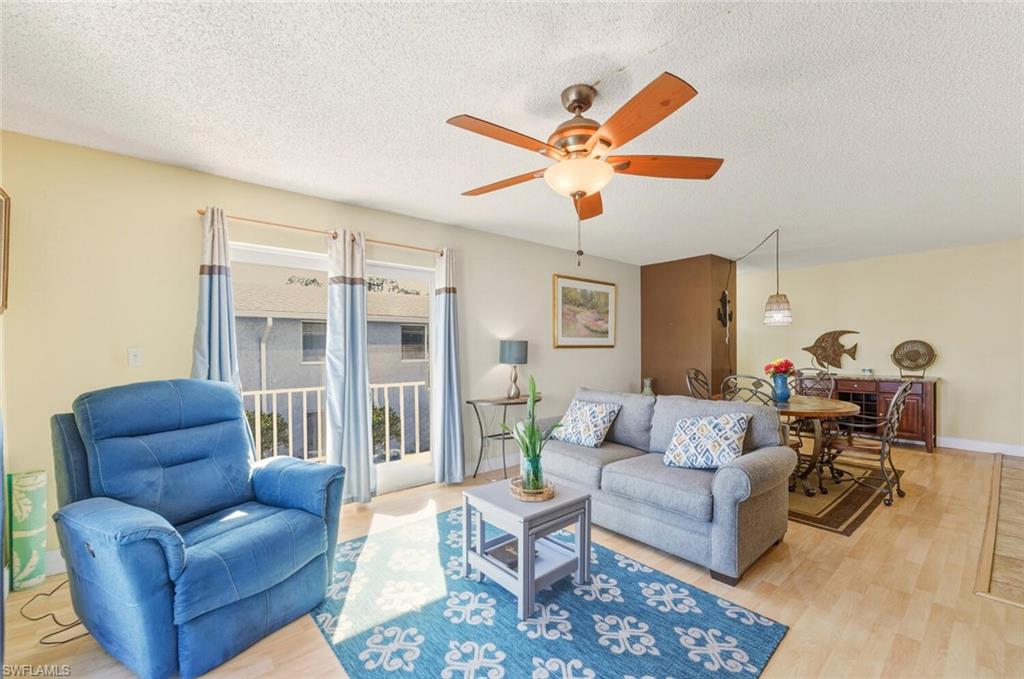 272 Palm Drive, Unit 2 Naples, FL 34112 - Photo 8 of 44 a living room with furniture and a large window