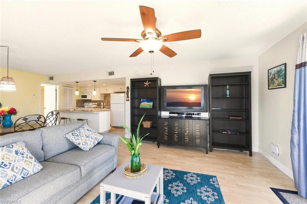 272 Palm Drive, Unit 2 Naples, FL 34112 - Photo 9 of 44 a living room with furniture and a flat screen tv