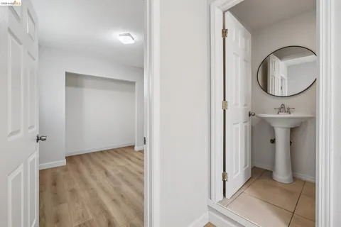 a view of a mirror light fixtures and entryway