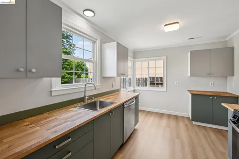 a kitchen with a sink and large window