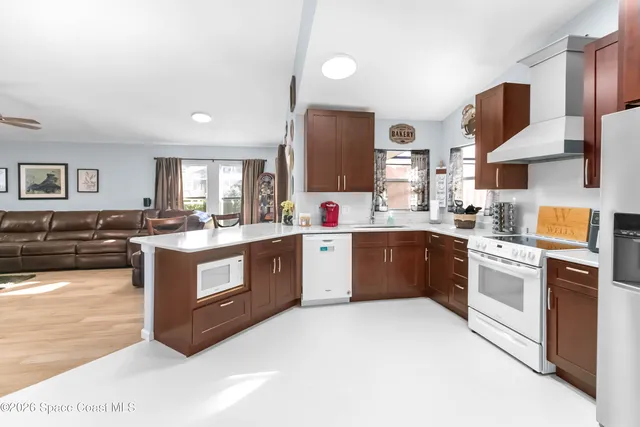 a kitchen with stainless steel appliances granite countertop a stove top oven and sink
