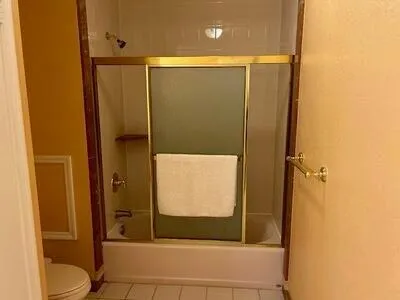 a bathroom with a shower and a toilet