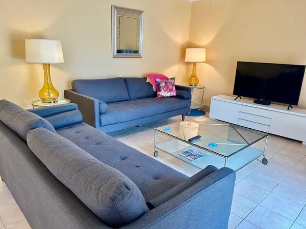 a living room with couches and a flat screen tv
