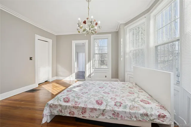 a bedroom with a bed and a chandelier