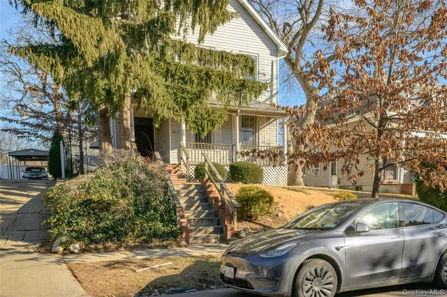 a front view of a house with parking area