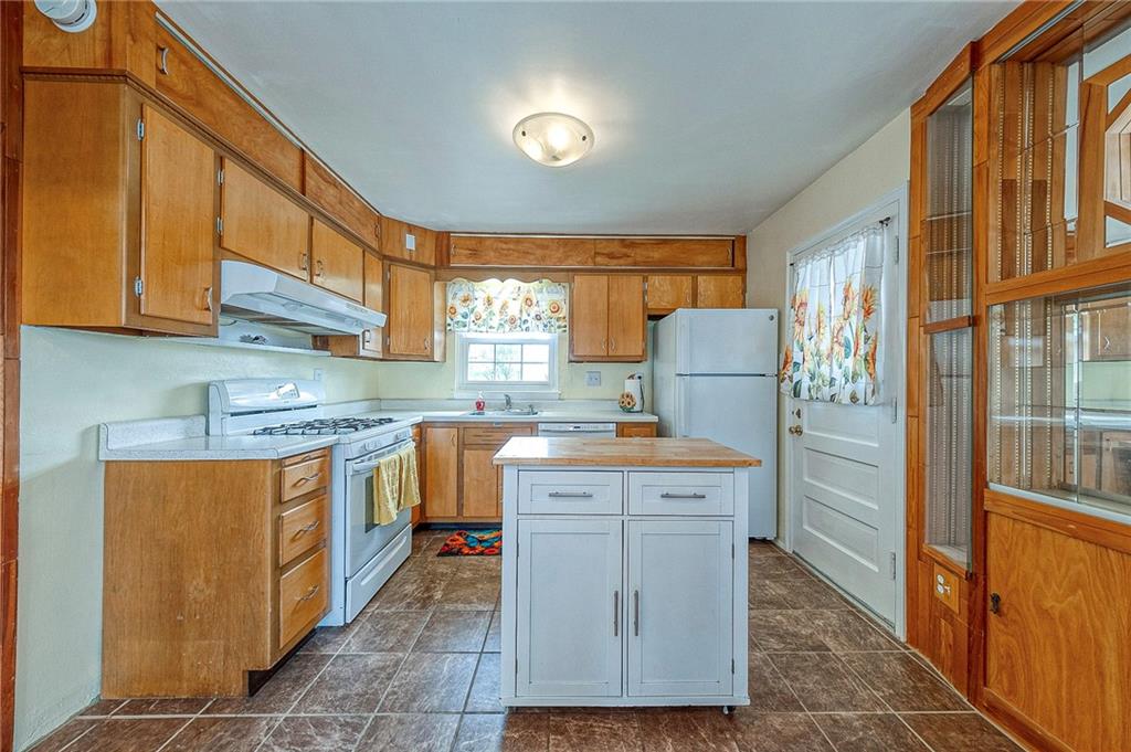 1816 Cardinal Avenue Aliquippa, PA 15001 - Photo 3 of 30 a kitchen with stainless steel appliances granite countertop a stove a sink and a refrigerator