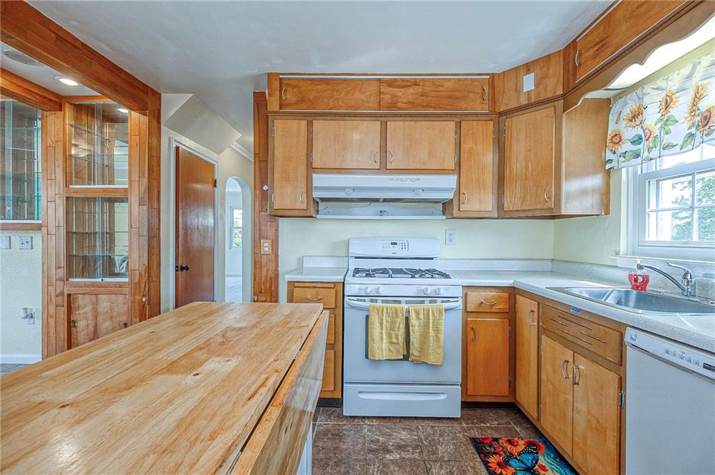 1816 Cardinal Avenue Aliquippa, PA 15001 - Photo 4 of 30 a kitchen with a sink stove and cabinets