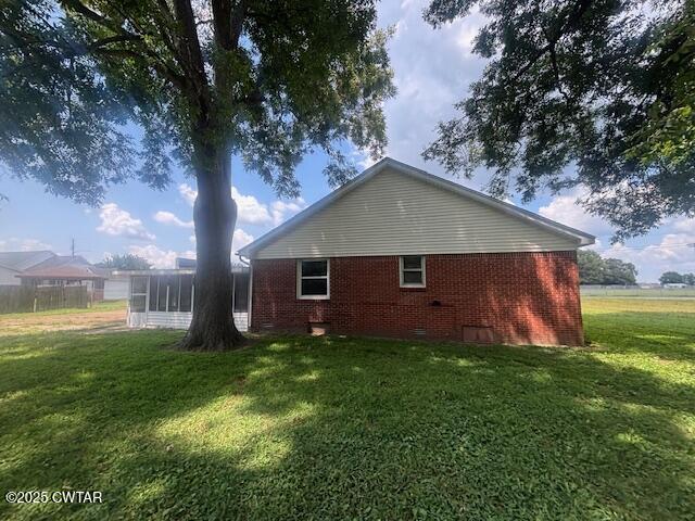 617 King Street Ridgely, TN 38080 - Photo 2 of 23 a house that is sitting in the grass with large trees and plants