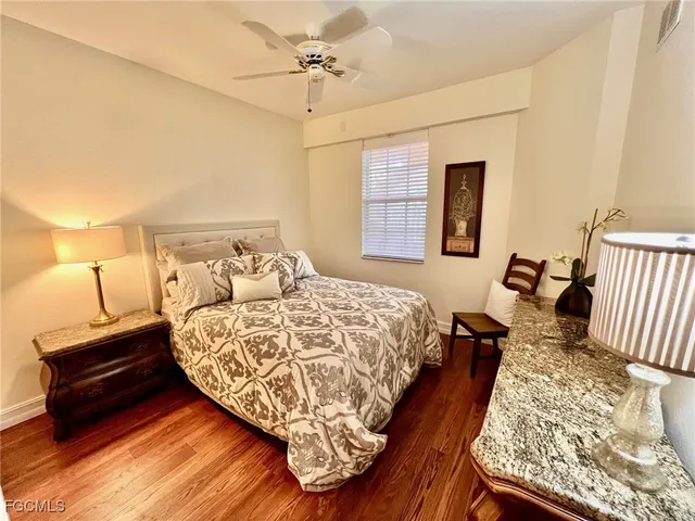 a bed room with a bed and a night stand