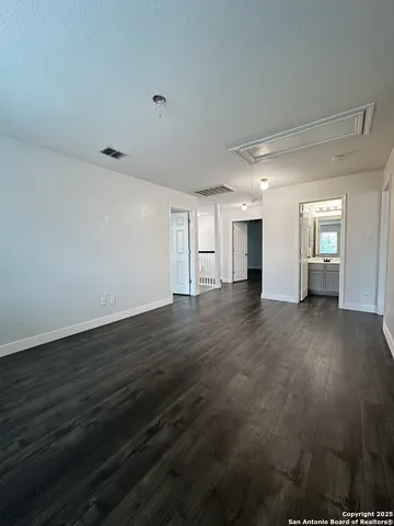 a view of a livingroom with wooden floor and staircase