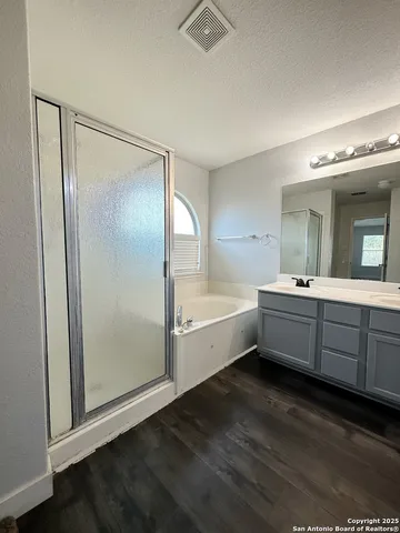 a large spacious bathroom with a double vanity sink a mirror and a bathtub