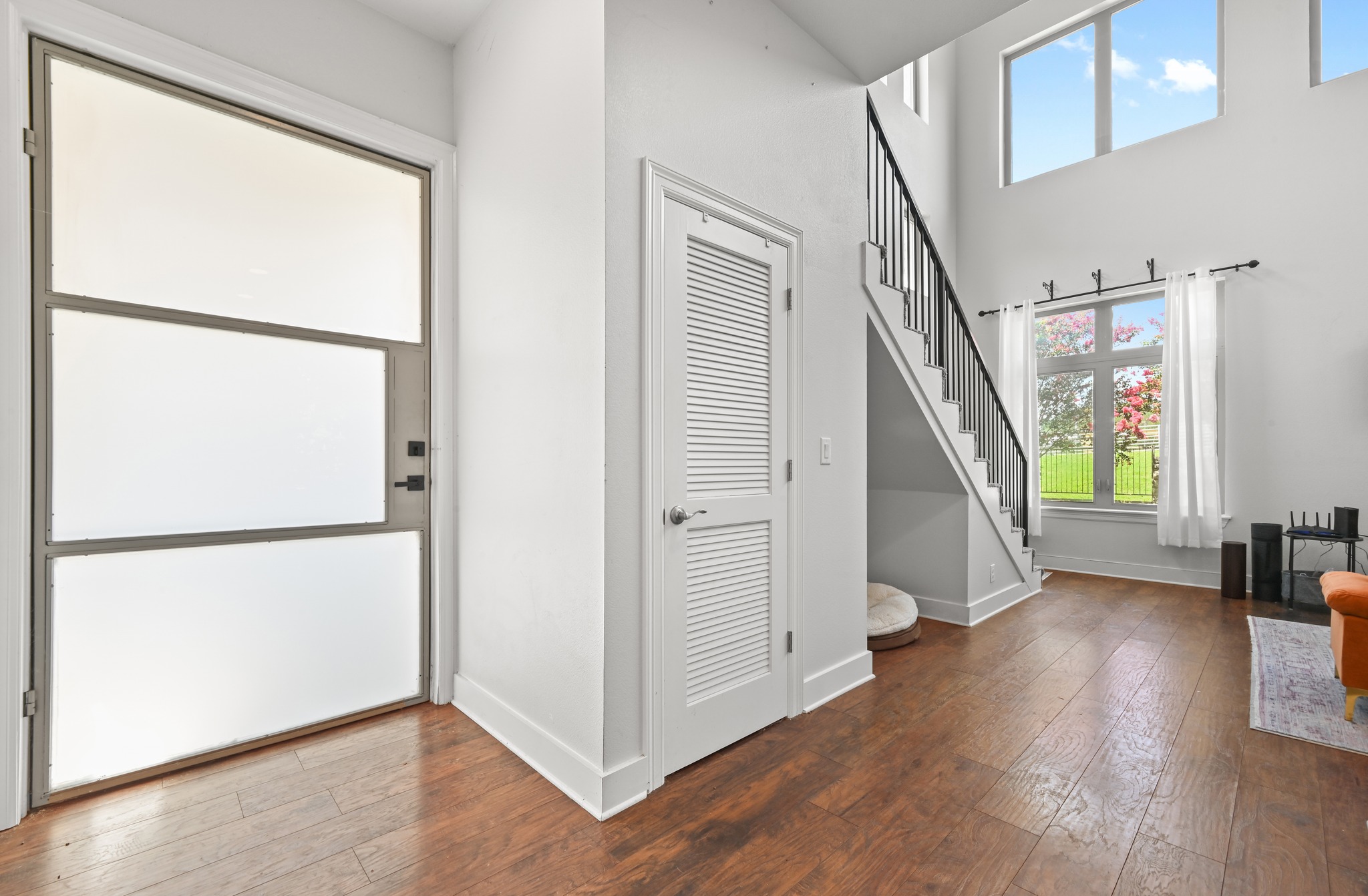 592 Farm To Market 967, Unit B Buda, TX 78610 - Photo 4 of 26 Step inside to soaring ceilings, rich wood floors, and a striking staircase that sets the tone for the stylish spaces that await throughout the home.