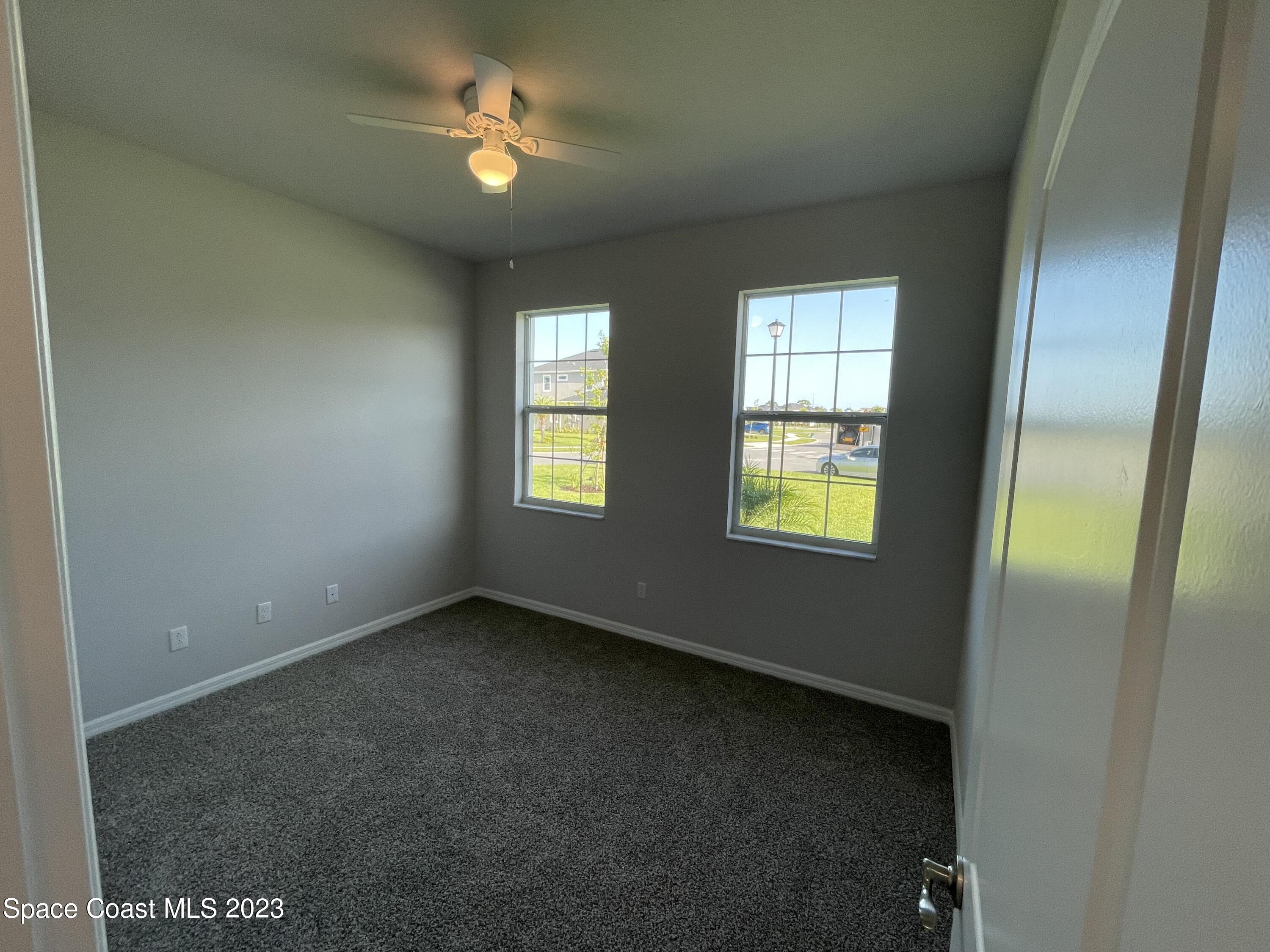 3085 Zeler Place Melbourne, FL 32940 - Photo 11 of 16 an empty room with windows and fan