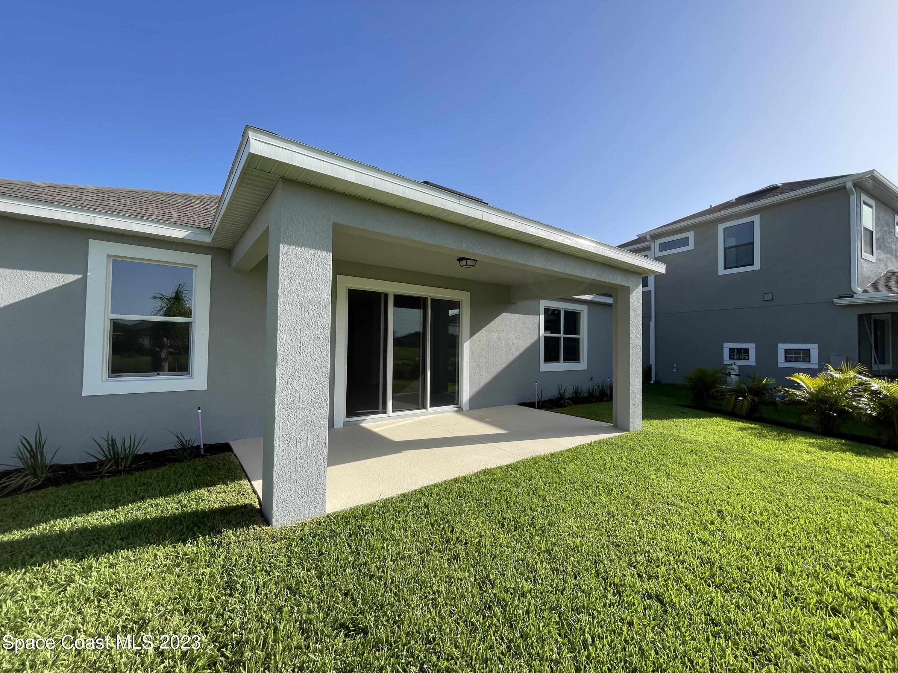 3085 Zeler Place Melbourne, FL 32940 - Photo 8 of 16 a view of a house with a yard and plants