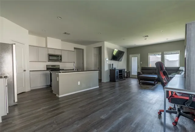 a kitchen with sink cabinets and wooden floor