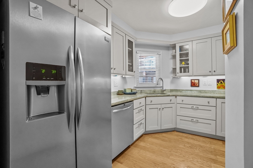 45 Main Street, Unit 112 Wareham, MA 02571 - Photo 9 of 30 a kitchen with stainless steel appliances granite countertop a refrigerator a stove and a sink