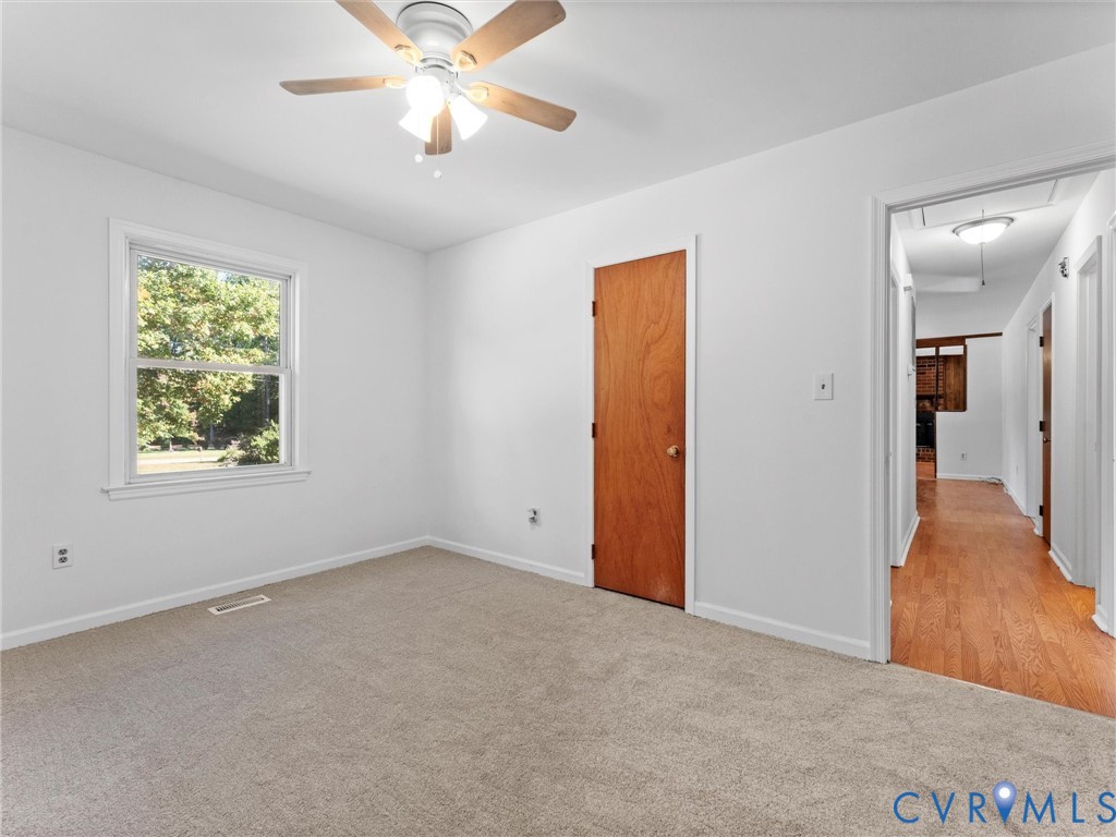 3913 Tavern Road Petersburg, VA 23805 - Photo 19 of 34 an empty room with a ceiling fan and a window
