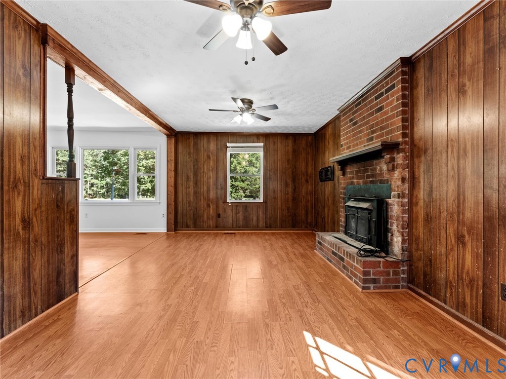 3913 Tavern Road Petersburg, VA 23805 - Photo 9 of 34 wooden floor in an empty room with a fireplace