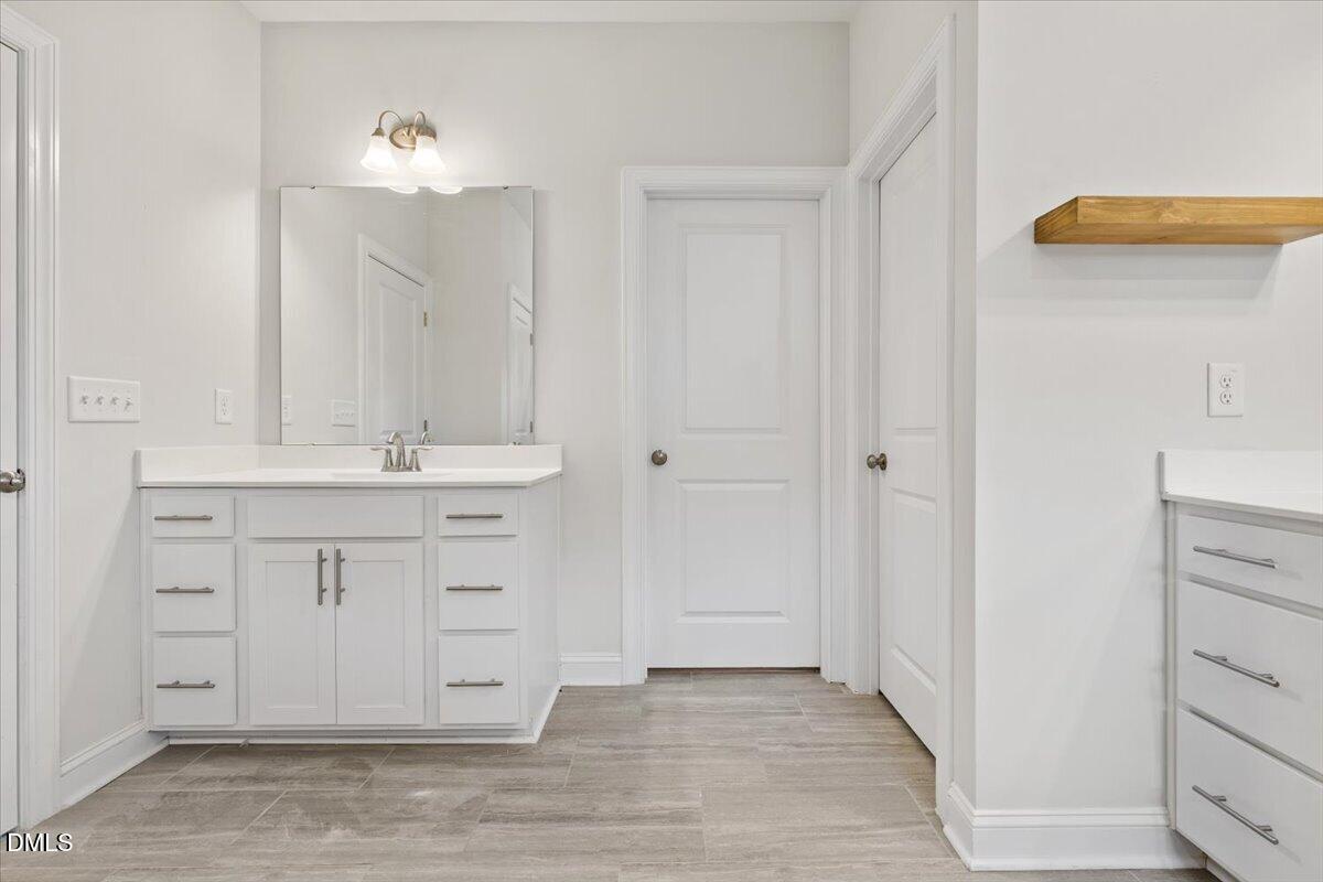 4937 Abundance Avenue Raleigh, NC 27616 - Photo 21 of 36 a bathroom with a sink vanity and a mirror