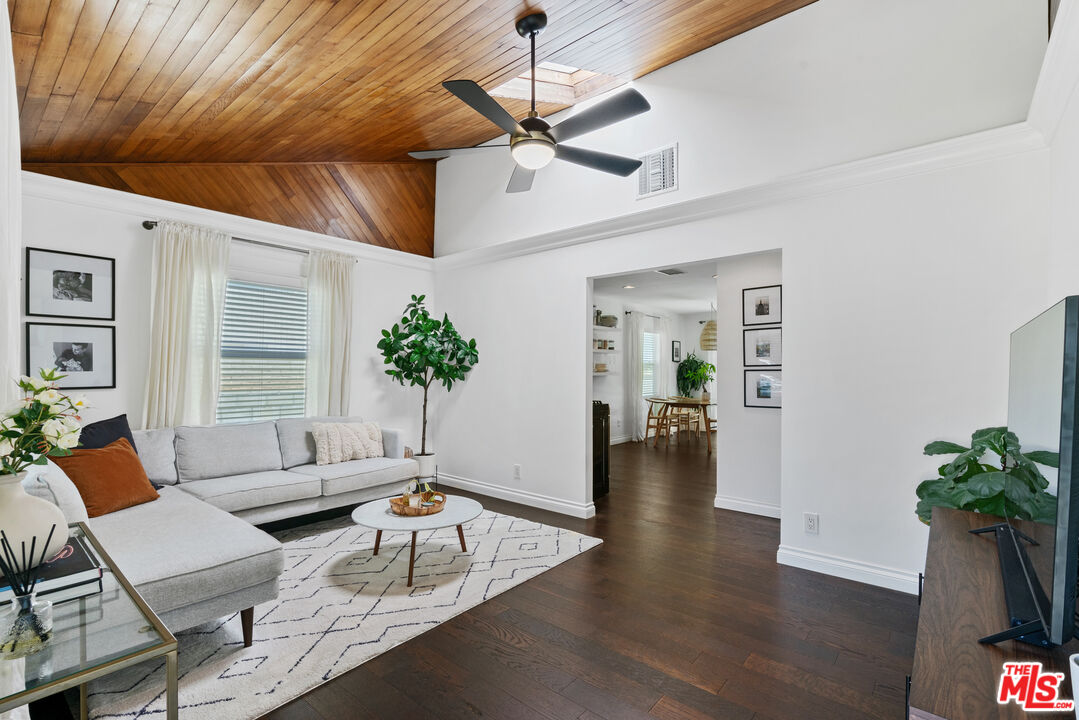 a living room with furniture and a potted plant