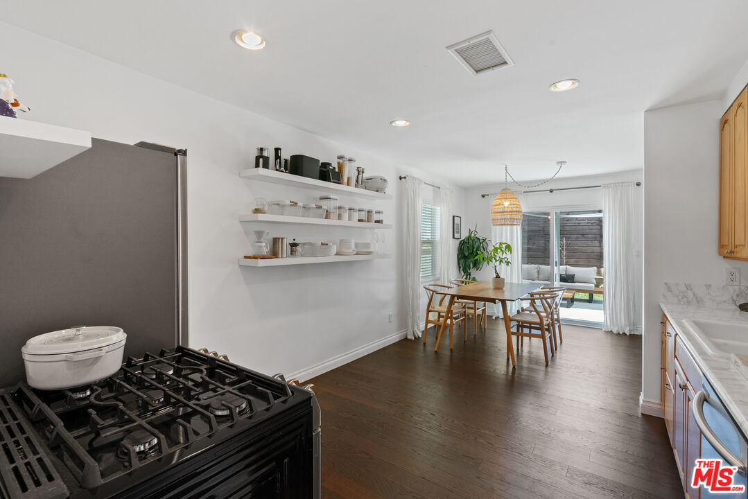 8000 Ramsgate Avenue Los Angeles, CA 90045 - Photo 5 of 23 a kitchen with stainless steel appliances a table and chairs in it