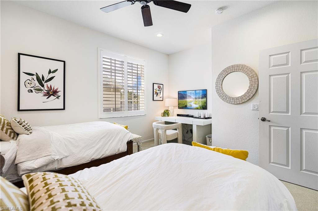 19071 Ridgepoint Drive, Unit 202 Estero, FL 33928 - Photo 13 of 26 a bedroom with two beds and a large window